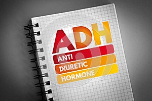 ADH - Antidiuretic Hormone acronym on notepad, concept background
