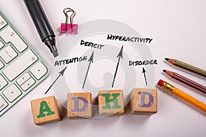 ADHD - Attention Deficit Hyperactivity Disorder. Wooden blocks on a white office table