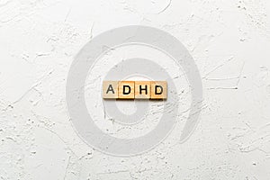 ADHD word written on wood block. ADHD text on table, concept