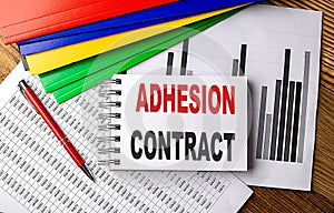 ADHESION CONTRACT text on notebook with folder on chart photo