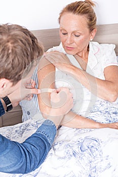 Adhesive bandage on arm of a woman