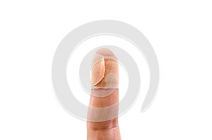 Adhesive bandage on a child`s index finger isolated on a white background with copy space.