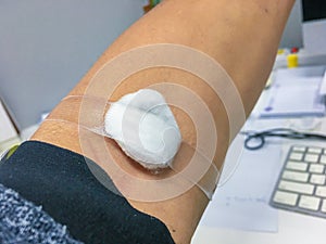 Adhesive bandage cotton on arm after Injection Vaccine, Medicine or Blood Collection . Medical Equipment, Soft focus Adhesive band