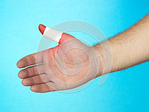 Adhesive bandage on finger tip.