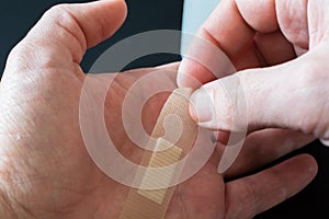 Adhesive Bandage on Men`s Finger.