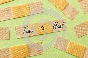 Adhesive bandage plasters and the text time to heal