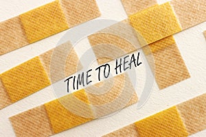 Adhesive bandage plasters and the text time to heal