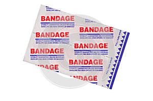 Adhesive first-aid bandages in packaging on white