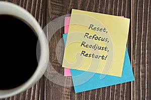 Adhesive note with inspirational text - Reset, refocus, readjust, restart