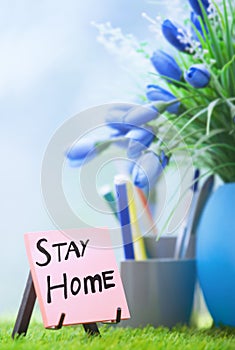 Adhesive note with Stay Home text at the green office