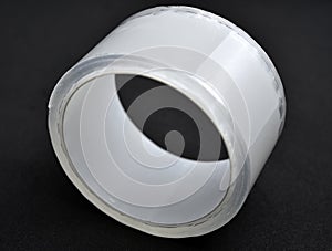 Adhesive tape on a black background. Rolls of transparent tape. Scotch tape on a black background