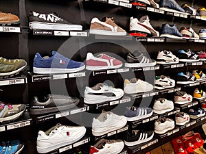 Adidas, Puma sport shoes in row at local mall.