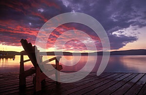 Adirondack chair on deck at sunrise.