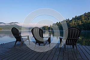 Adirondack Chairs on a Dock on a lake in the early morning