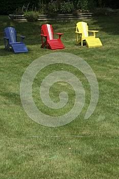 Adirondack chairs on manicured lawn