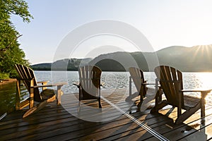 Adirondack deck chairs on lake dock photo