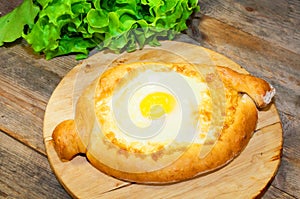 Adjara khachapuri bread on a board cheese and egg