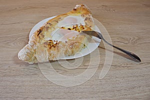 Adjarian khachapuri close-up. This traditional georgian dish contains brinsen cheese, butter and row egg