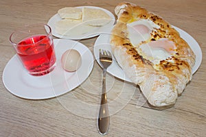 Adjarian khachapuri close-up. This traditional georgian dish contains brinsen cheese, butter and row egg