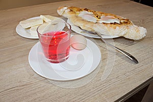 Adjarian khachapuri close-up. This traditional georgian dish contains brinsen cheese, butter and row egg