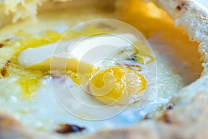 Adjarian khachapuri with eggs and butter on the table