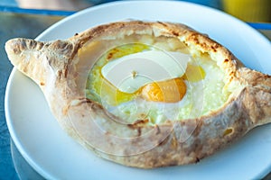 Adjarian khachapuri with eggs on the table