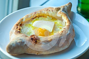 Adjarian khachapuri with eggs on the table