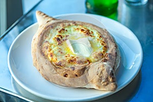 Adjarian khachapuri with eggs on the table