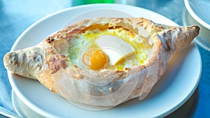 Adjarian khachapuri with eggs on the table