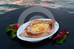 Adjarian khachapuri with eggs on table