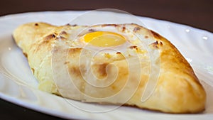 Adjarian khachapuri with eggs on the table