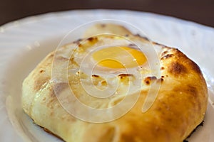 Adjarian khachapuri with eggs on the table