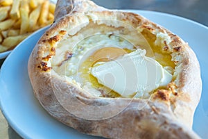 Adjarian khachapuri with eggs on the table