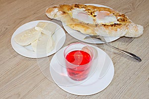 Adjarian khachapuri with eggs on the table