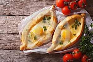 Adjarian khachapuri and vegetables horizontal top view