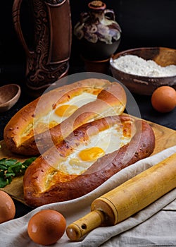 Adjarian khachapuri on a wooden Board. Homemade cake