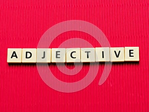 ADJECTIVE word made from square letter tiles photo