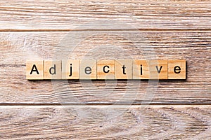 Adjective word written on wood block. adjective text on wooden table for your desing, concept