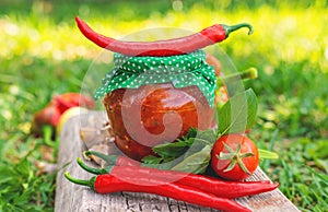 Adjika in a jar, canned. Selective focus.