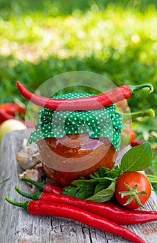 Adjika in a jar, canned. Selective focus.