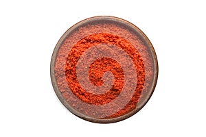 Adjika powder spice in wooden bowl, isolated on white background. Seasoning top view