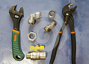 Adjust wrench power grip, groove joint pillers and elements of water and gas shutoff valves, flat lay