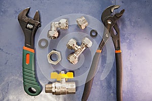 Adjust wrench power grip, groove joint pillers and elements of water and gas shutoff valves, flat lay
