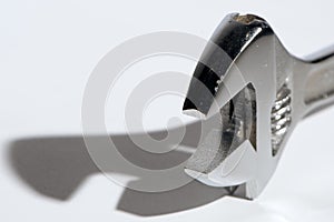 Adjustable crescent wrench with shadow on white background