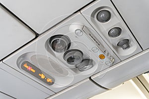 Adjustable ights and air conditioners overhead seat controls of a commercial aircraft in an airplane with no-smoking and seat belt