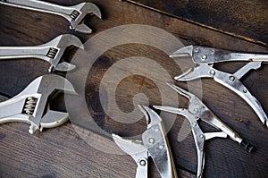Adjustable wrench or spanner wrench and Locking pliers on wooden background, Prepare basic hand tools for work