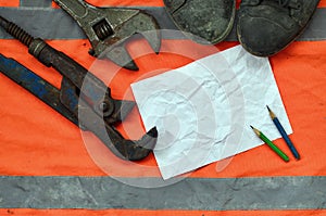 Adjustable wrenches with old boots and a sheet of paper with two