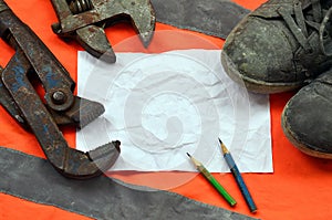 Adjustable wrenches with old boots and a sheet of paper with two