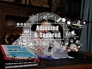 Adjusted R-Squared concept with young businesswoman working office on background