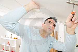 Adjusting fixing cabinet door hinge using screwdriver